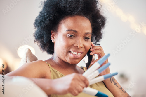 Pregnancy test, black woman and phone call on sofa for good news, announcement and surprised. Pregnant, female and home testing kit for positive, results or sharing ivf success on call in living room