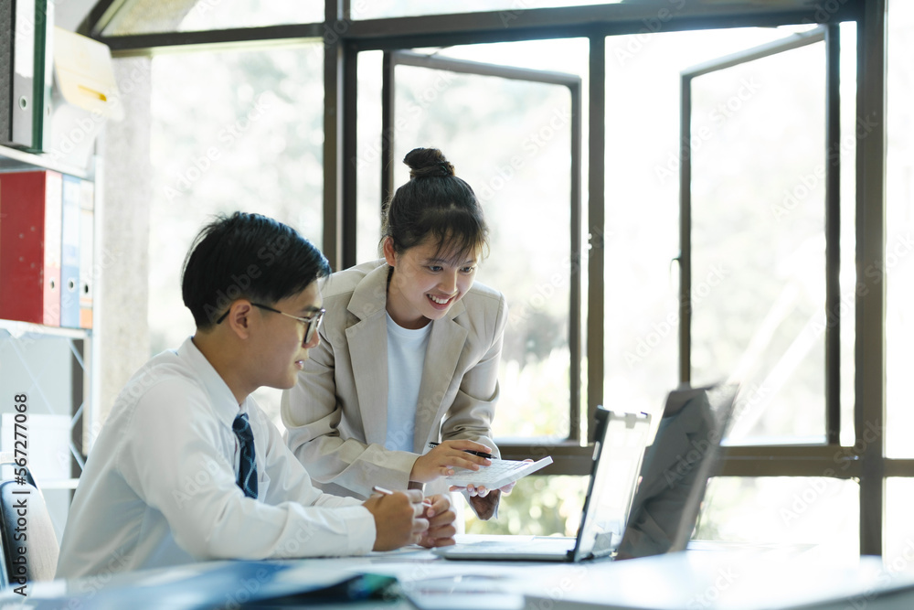 Businesspeople are working by discuss and analyses their project by using laptop and calculator. Businesspeople are working by discuss and analyses their project by using laptop and calculator.