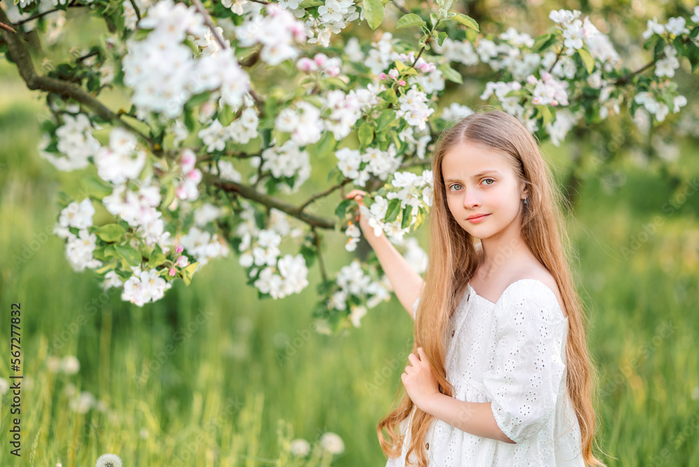 Portrait of laughing girl under falling petals of cherry blossom flowers in spring. Portrait of laughing girl under falling petals of cherry blossom flowers in spring.