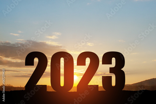 Silhouette 2023 with sunset sky at mountain and number like 2023 abstract background.