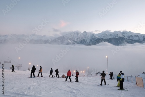 Billede på lærred Ski slope with silhouettes of skiers descending on Gubałowka hill, Tatras Mountains, Zakopane, Poland