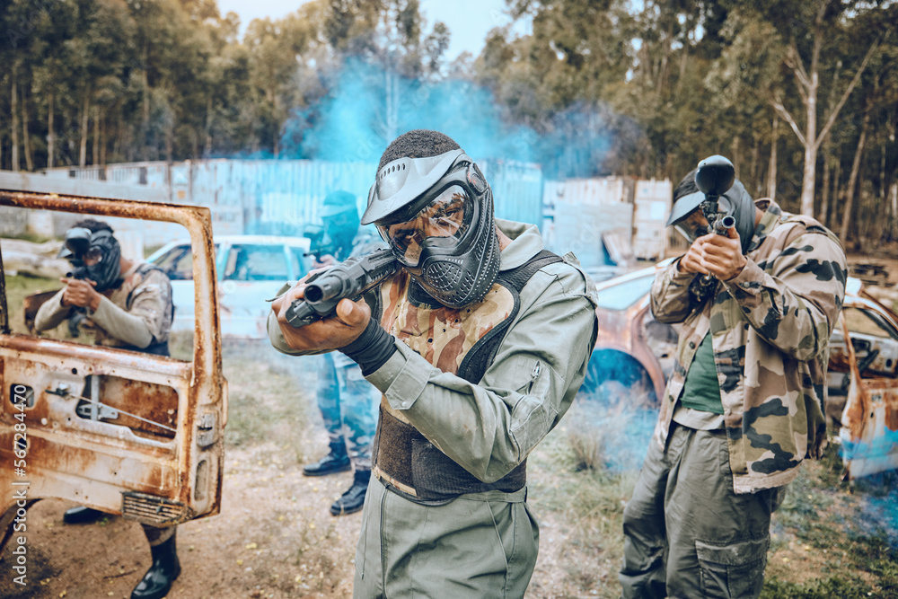 Fototapeta premium Teamwork, paintball and sports with people in field for hero, target and shooting games. War, smoke and community with man gamer playing in camouflage for military, army and competition training