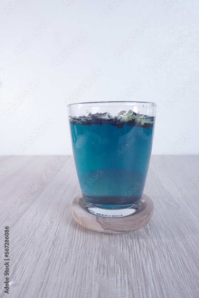 Teh Bunga Telang, Butterfly pea tea with wooden coaster Teh Bunga Telang, Butterfly pea tea with wooden coaster