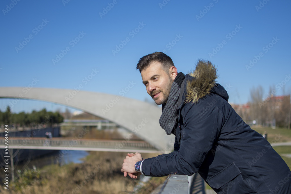 Portrait of a handsome man standing on the street, Fashion model standing outdoors Portrait of a handsome man standing on the street, Fashion model standing outdoors