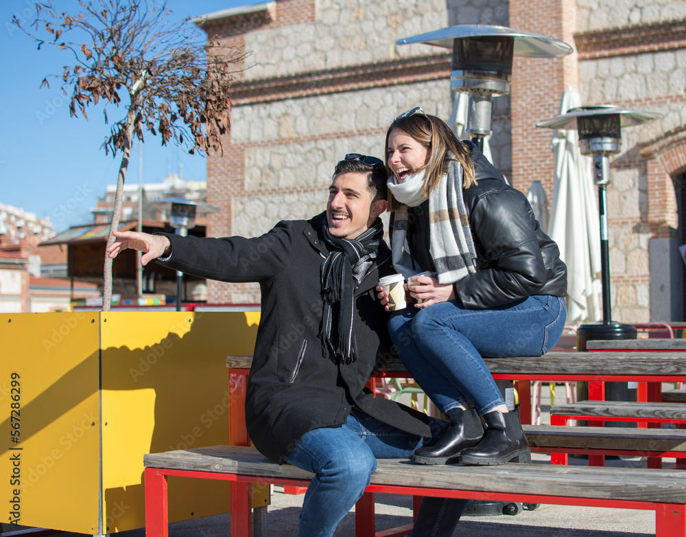 Fototapeta premium Couple dating in a coffeehouse bar - Tourists talking and having fun while sightseeing the city