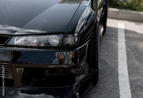 Modern car headlight close up.