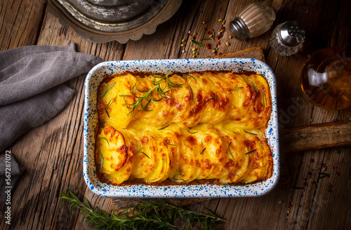 Potato gratin - graten (baked potatoes with cream and cheese) with rosemary and forks (Turkish name; Kremali patates) photo