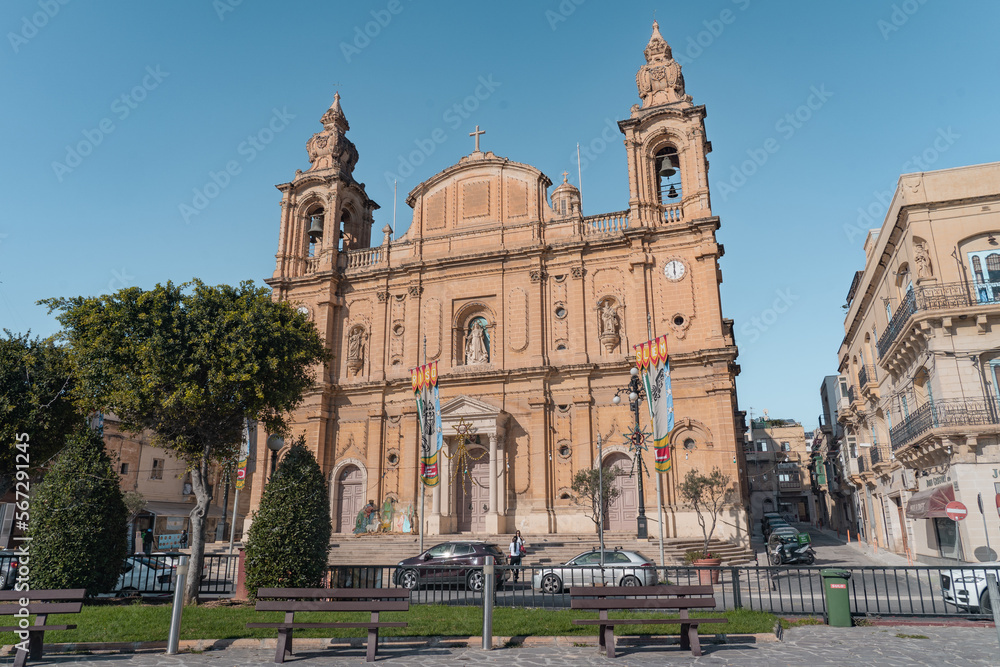 Maida Parish Church in Msida with trees in front