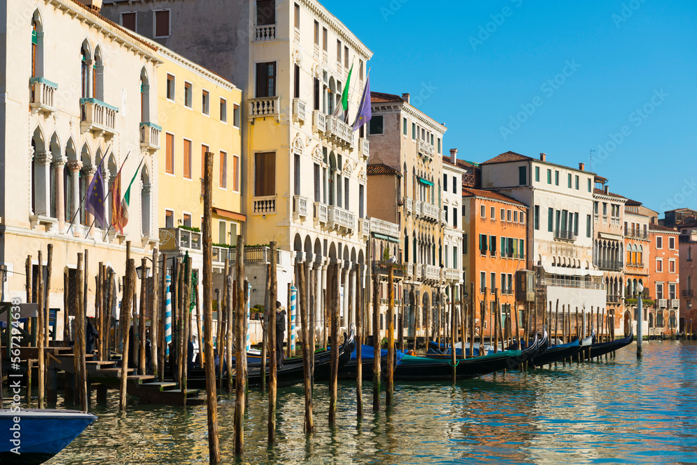 Gondola and Beautiful Houses on the Waterfront in a Sunny Day in Venice, Veneto in Italy. Gondola and Beautiful Houses on the Waterfront in a Sunny Day in Venice, Veneto in Italy.