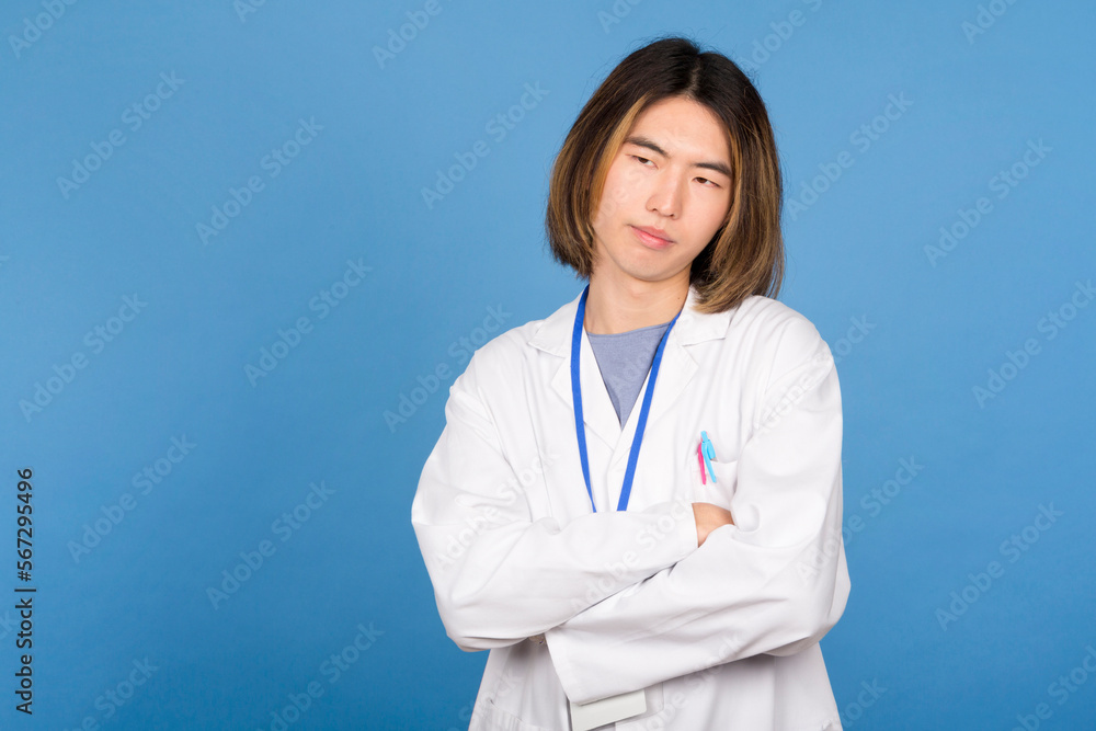 A bored asian doctor with arms crossed A bored asian doctor with arms crossed