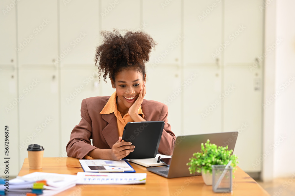 Smiling female financial advisor using tablet for checking information or chatting online with her client Smiling female financial advisor using tablet for checking information or chatting online with her client
