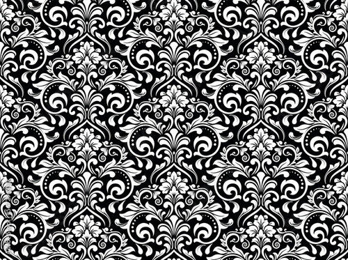 Wallpaper in the style of Baroque. Seamless vector background. White and black floral ornament. Graphic pattern for fabric, wallpaper, packaging. Ornate Damask flower ornament