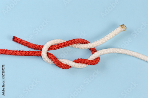 Not tightened rope Surgeon's knot on a blue background