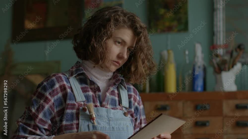 Artist Creating Artwork. Female painter working in workshop. Woman in art space. Artist Creating Artwork. Female painter working in workshop. Woman in art space.