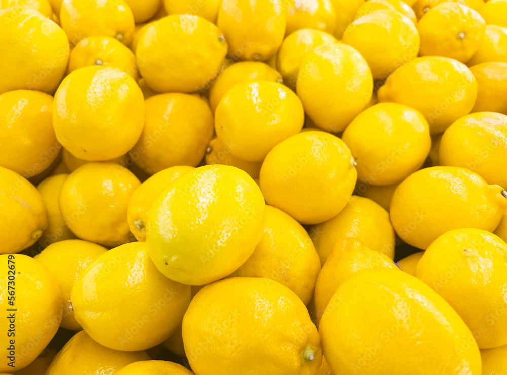 Ripe whole yellow lemon citrus fruit texture background. Fresh lemon fruit pattern.