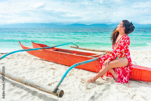 Transgender woman posing in colorful swimwear,on a boat,White Beach,Moalboal,Cebu Island,Philippines.