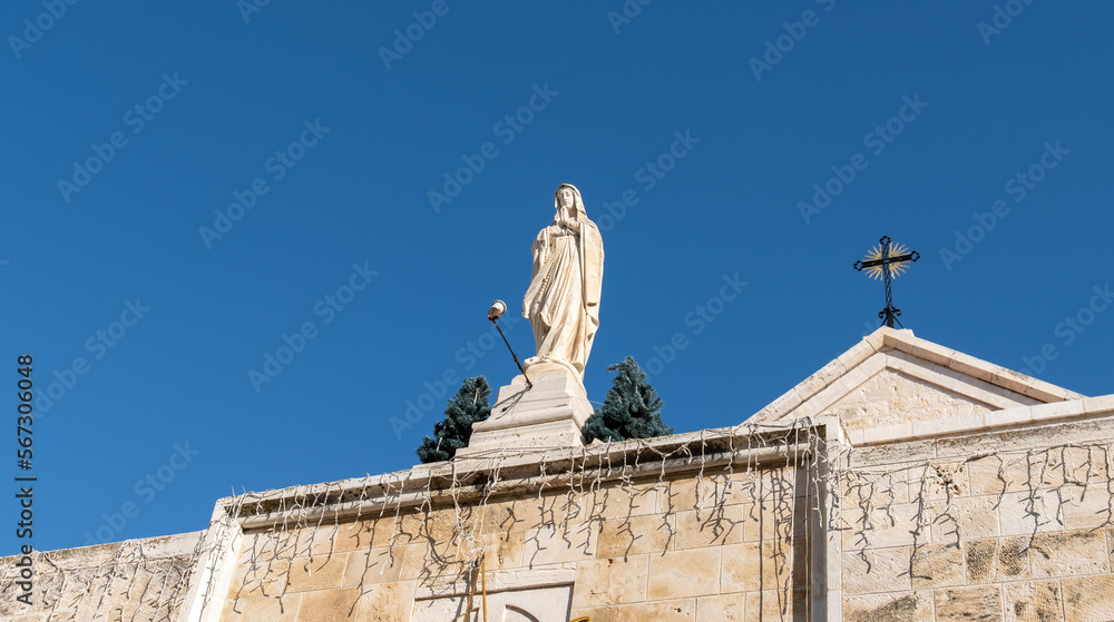 Naklejka premium Statue of St.Catherine on the roof Church of Saint Catherine, Bethlehem