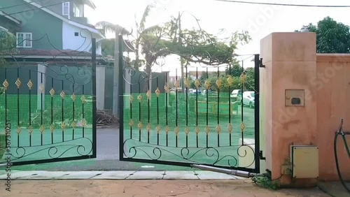 Time lapse video of a badly spoiled and damaged electric automatic gate going haywire moving and swinging on its own photo