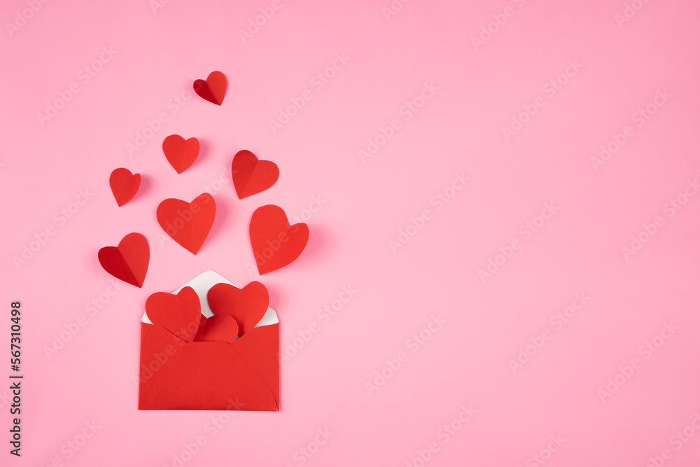 Envelope containing a heart shape for romance and valentines day copy space