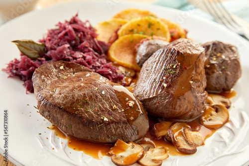 Spicy venison and mushrooms with sauerkraut and potatoes