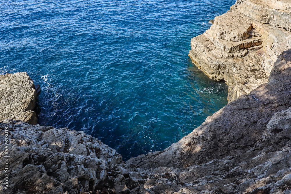 Rocky Cliff Shore with Adriatic Sea. Blue Water with Stone in Croatia. European Outdoor Nature. Rocky Cliff Shore with Adriatic Sea. Blue Water with Stone in Croatia. European Outdoor Nature.