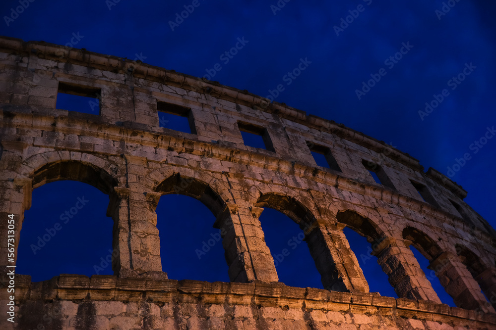 Pula Arena in Istria during Evening. Beautiful Roman Amphitheater with Night Sky in Croatia.