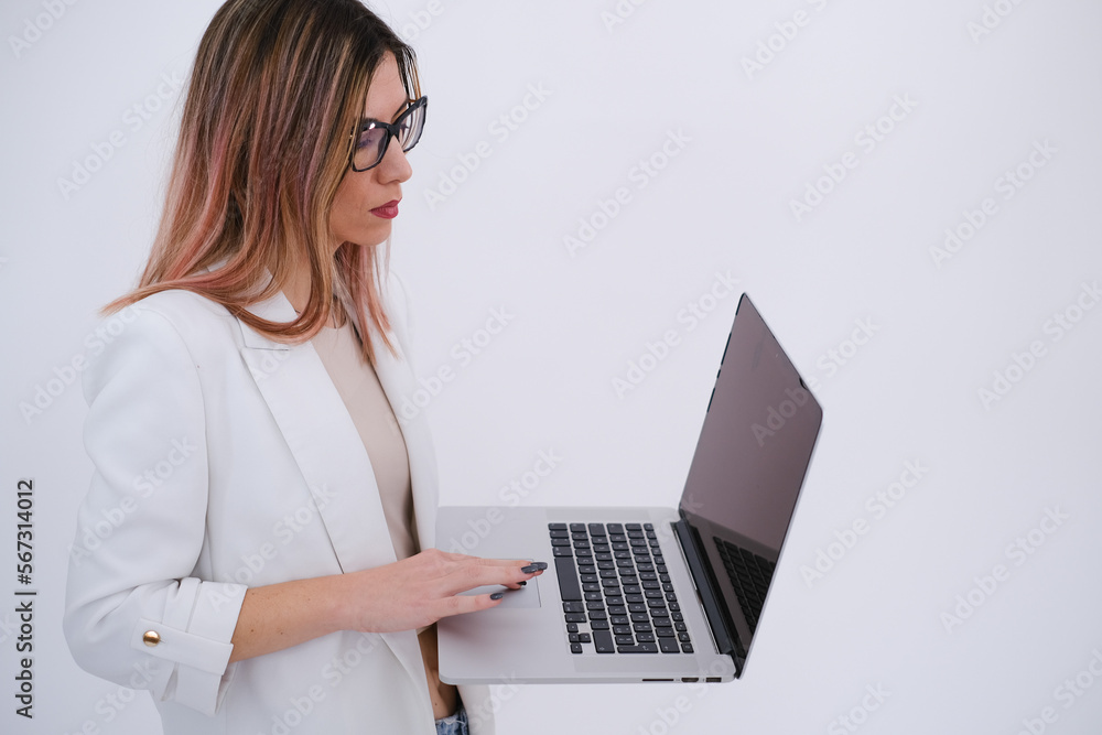 Business woman in white jacket holding a laptop. Independent woman. Businesswoman. Working woman. Entrepreneur. White background. Copy space. Business woman in white jacket holding a laptop. Independent woman. Businesswoman. Working woman. Entrepreneur. White background. Copy space.