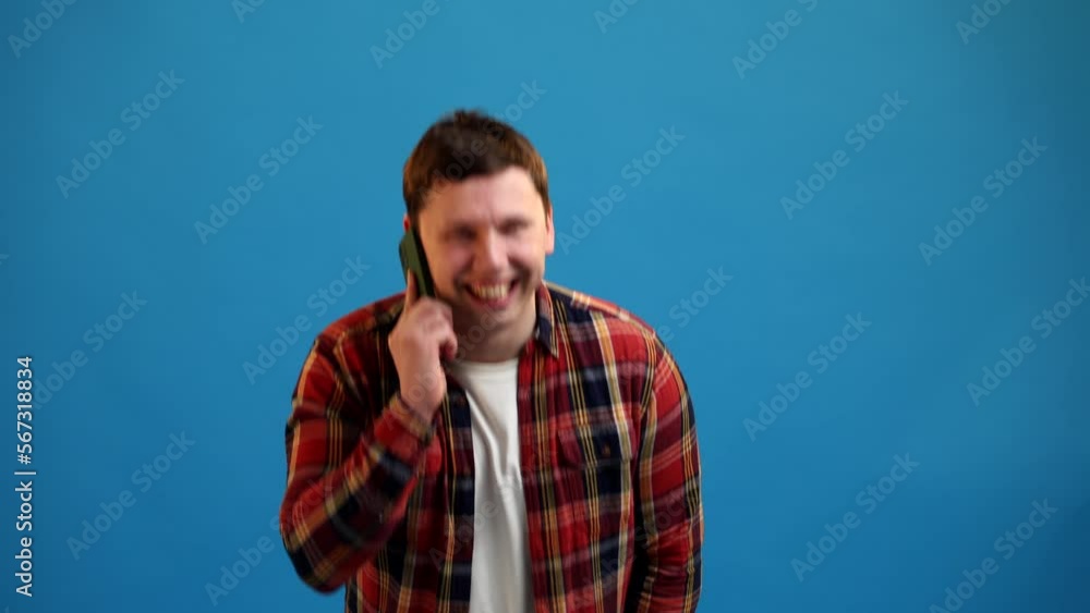 Young european man talking on phone enjoy friendly remotely communication against blue studio background. Businessman talking on smartphone discuss work project with partner Young european man talking on phone enjoy friendly remotely communication against blue studio background. Businessman talking on smartphone discuss work project with partner