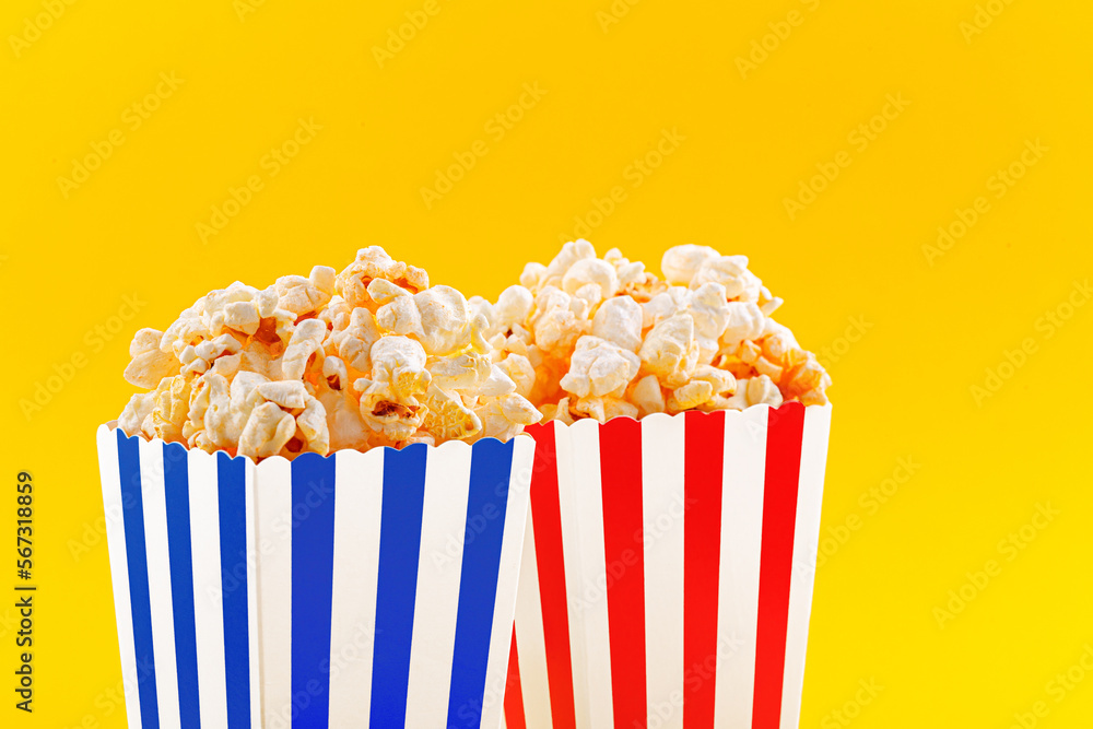 Glass with popcorn on a yellow background