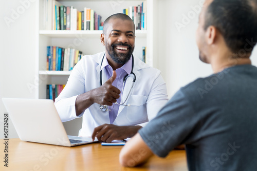 Mature adult african american male doctor talking to patient