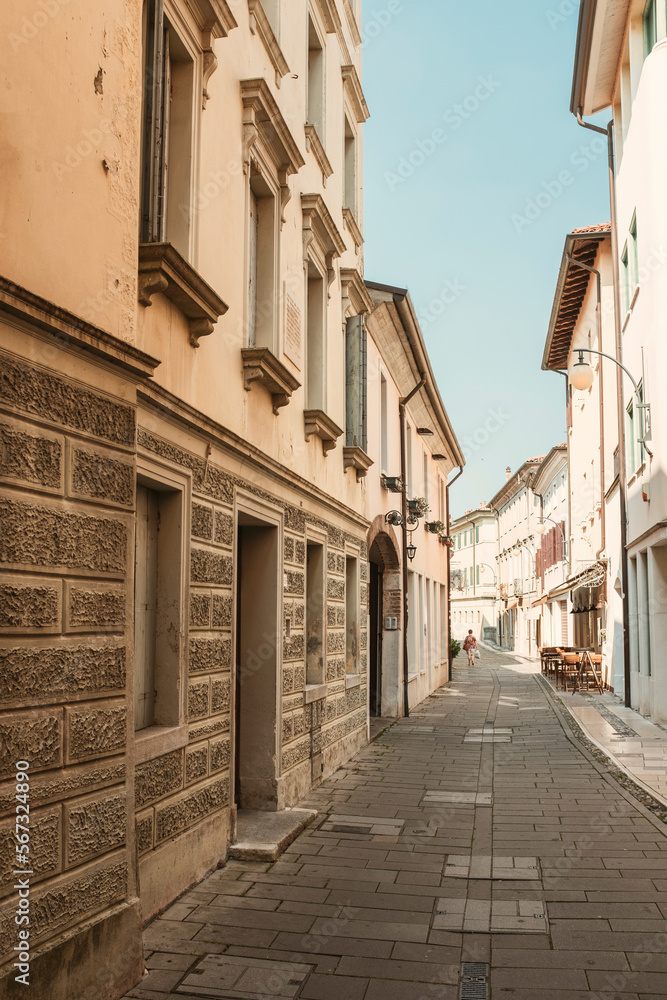 Narrow footpath amidst buildings in city against clear sky