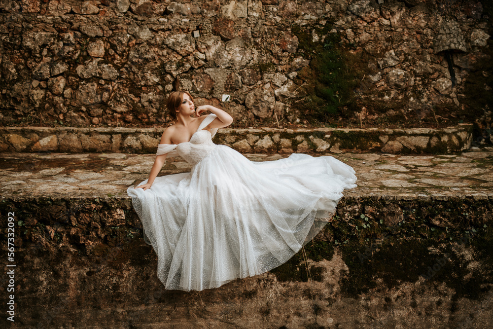 Dreamy portraits of beautiful bride on stone riverbank Dreamy portraits of beautiful bride on stone riverbank