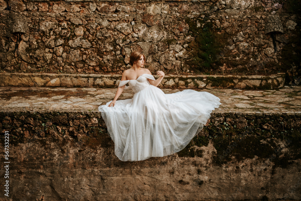 Dreamy portraits of beautiful bride on stone riverbank Dreamy portraits of beautiful bride on stone riverbank