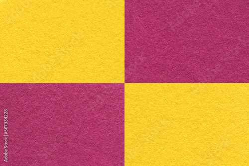 Texture of craft yellow and wine paper background with cells pattern, macro. Vintage kraft golden and purple cardboard.