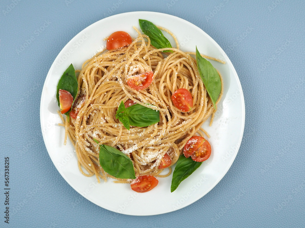 Spaghetti pasta with cherry tomatoes, basil and parmesan cheese.