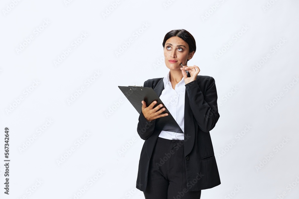Business woman folder with documents in black business suit shows signals gestures and emotions on white background, freelancer job online time management Business woman folder with documents in black business suit shows signals gestures and emotions on white background, freelancer job online time management