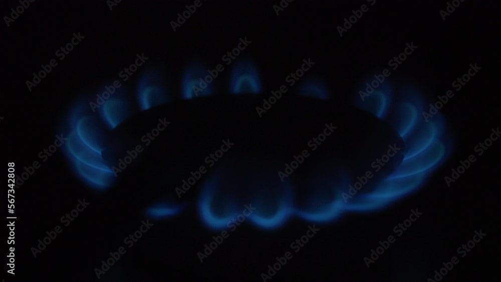 Kitchen burner flaming in the night on a kitchen cooker at night. Home fire in kitchen oven. burning gas. Kitchen burner flaming in the night on a kitchen cooker at night. Home fire in kitchen oven. burning gas.