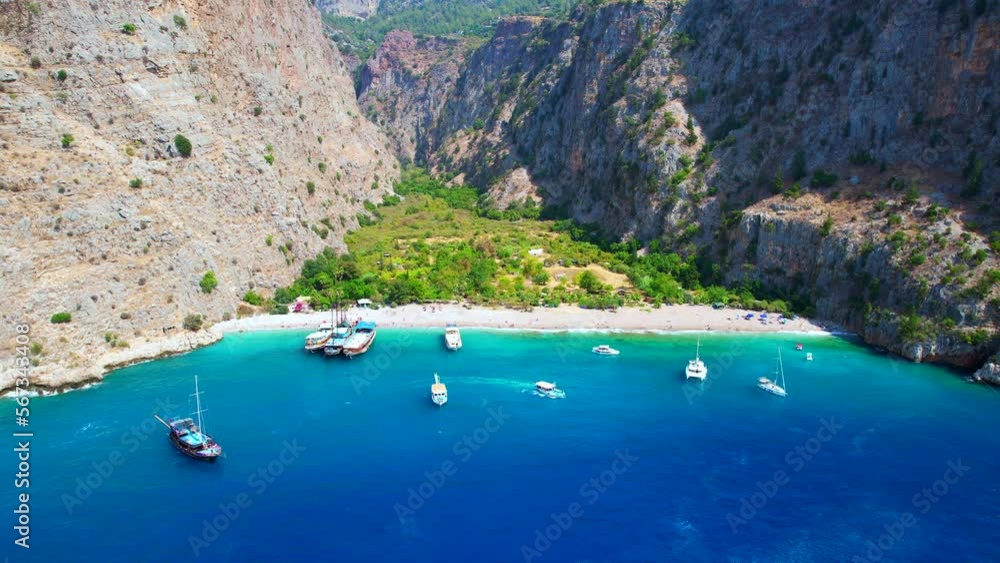 Butterfly Valley (Turkish: Kelebekler Vadisi) in Oludeniz. Beautiful beach aerial view with drone. Fethiye, Mugla, Turkey. Butterfly Valley (Turkish: Kelebekler Vadisi) in Oludeniz. Beautiful beach aerial view with drone. Fethiye, Mugla, Turkey.