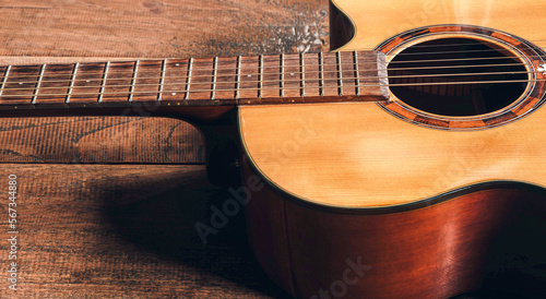 Top view of classical guitar on old wooden background.dark tone