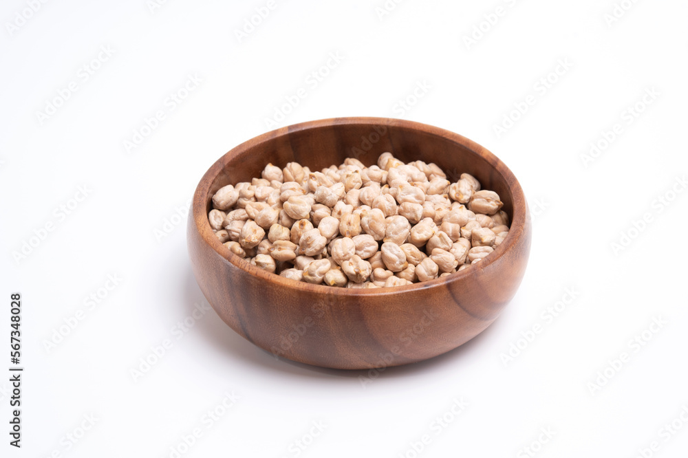 Uncooked chickpeas in wooden bowl. Healthy food concept Uncooked chickpeas in wooden bowl. Healthy food concept