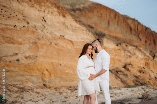 a guy with a girl in white clothes on the seashore