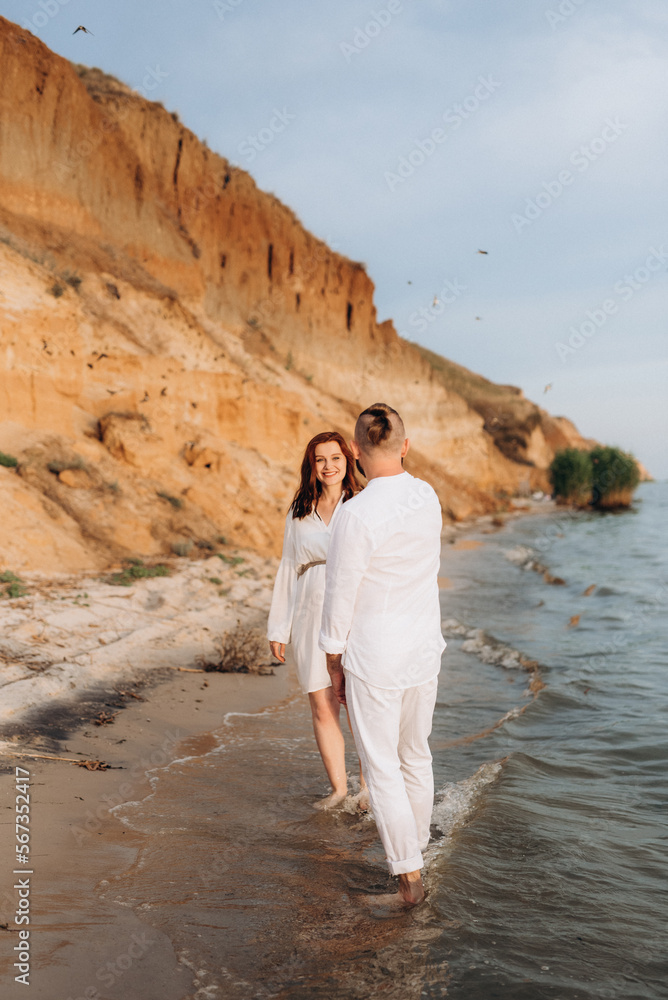 a guy with a girl in white clothes on the seashore a guy with a girl in white clothes on the seashore