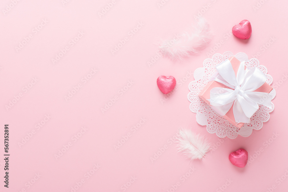 A mock-up of a Valentine's Day banner with a gift box, heart-shaped candies on a pink background. A mock-up of a Valentine's Day banner with a gift box, heart-shaped candies on a pink background.