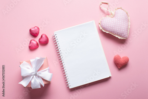 An open notebook with a gift and sweets on a light pink background. Valentine's day. © Irina Lesovaia
