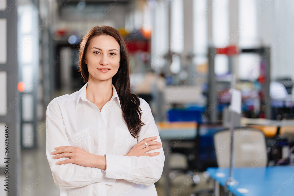 a brunette woman in a white shirt in an office. the business portrait. a brunette woman in a white shirt in an office. the business portrait.