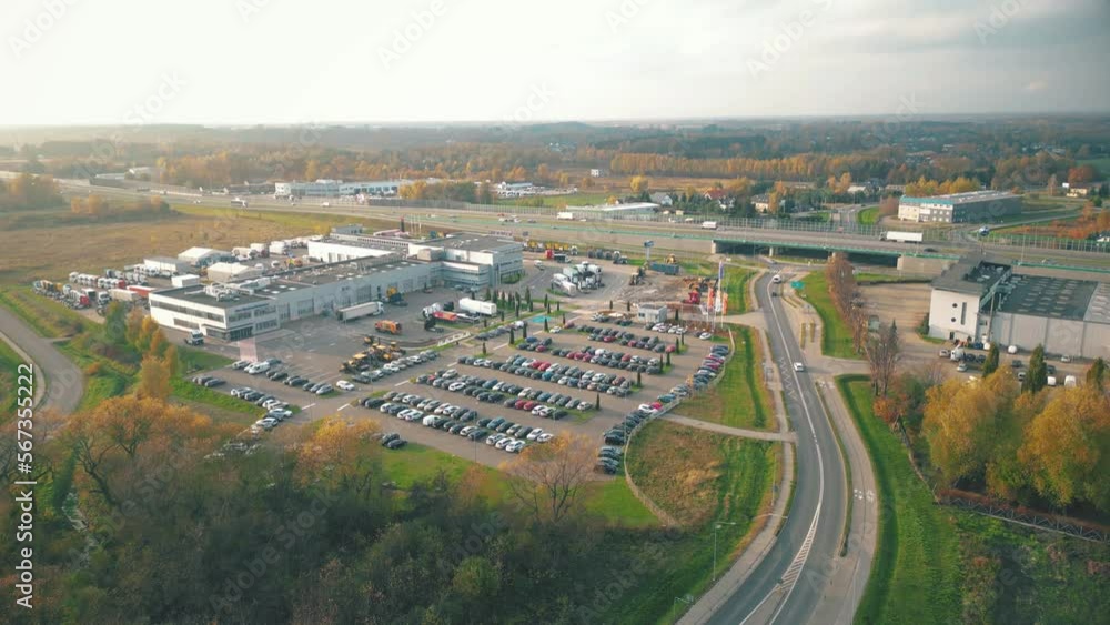 Warehouses, huge logistics center near the highway, view of a large number of cargo trailers and containers, international cargo transportation, aerial view. Warehouses, huge logistics center near the highway, view of a large number of cargo trailers and containers, international cargo transportation, aerial view.