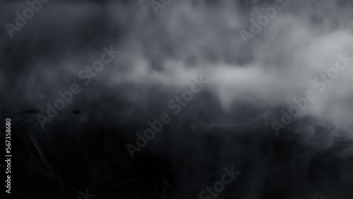 Super Slow Motion Shot of Abstract Flowing Smoke Isolated on Black at 1000fps. photo