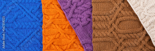 Knitted blue  lilac  brown  orange and beige background. Large knitted fabric with a pattern. Close-up of a knitted blanket. Banner