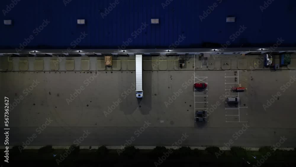 Huge logistics center at night, view of a large number of cargo trailers and containers, international cargo transportation, parking space, night time aerial view. Huge logistics center at night, view of a large number of cargo trailers and containers, international cargo transportation, parking space, night time aerial view.