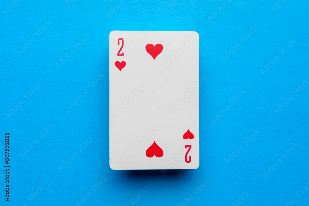 Playing card deuce of hearts on a blue background